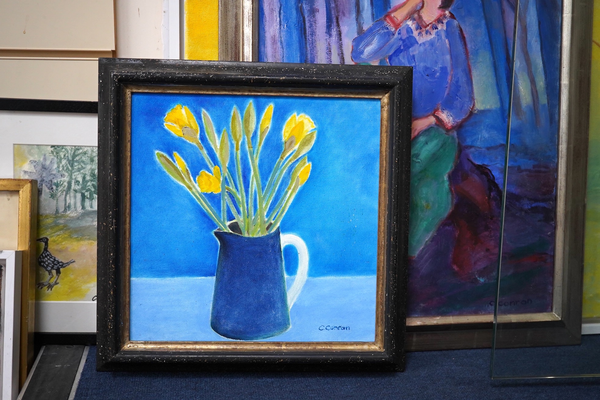 Caroline Conran (b.1939), oil on canvas, Still life of daffodils in a jug, signed, 29 x 29cm. Condition - good